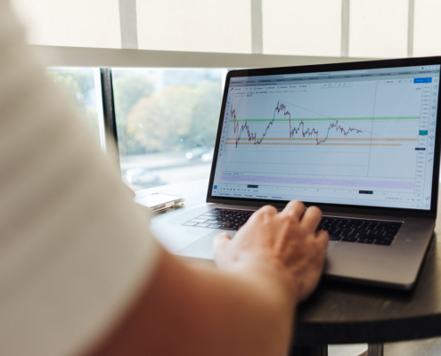 Laptop showing trading chart on screen